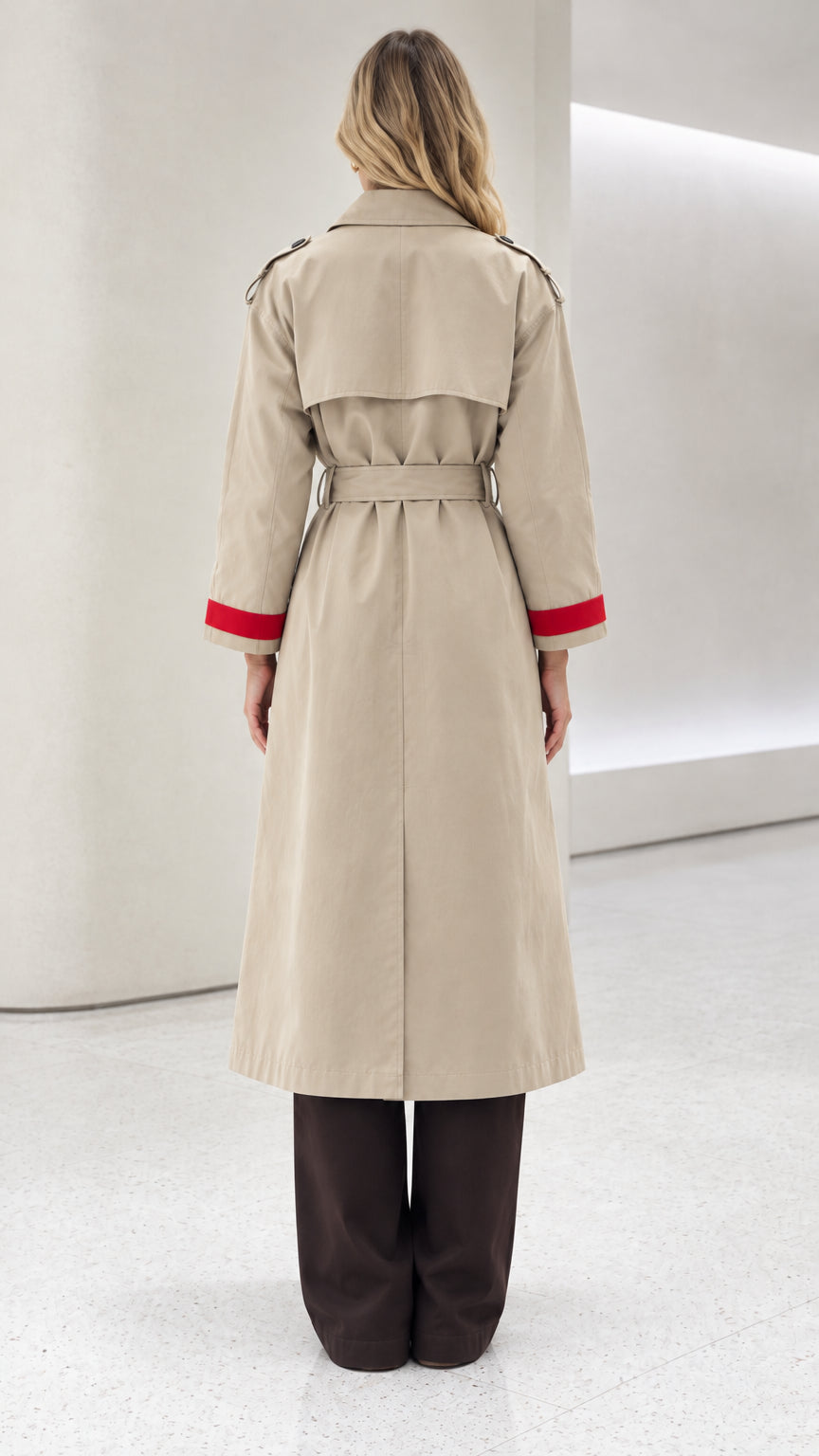 Back view of model wearing beige belted trench coat showing back storm flap and center vent