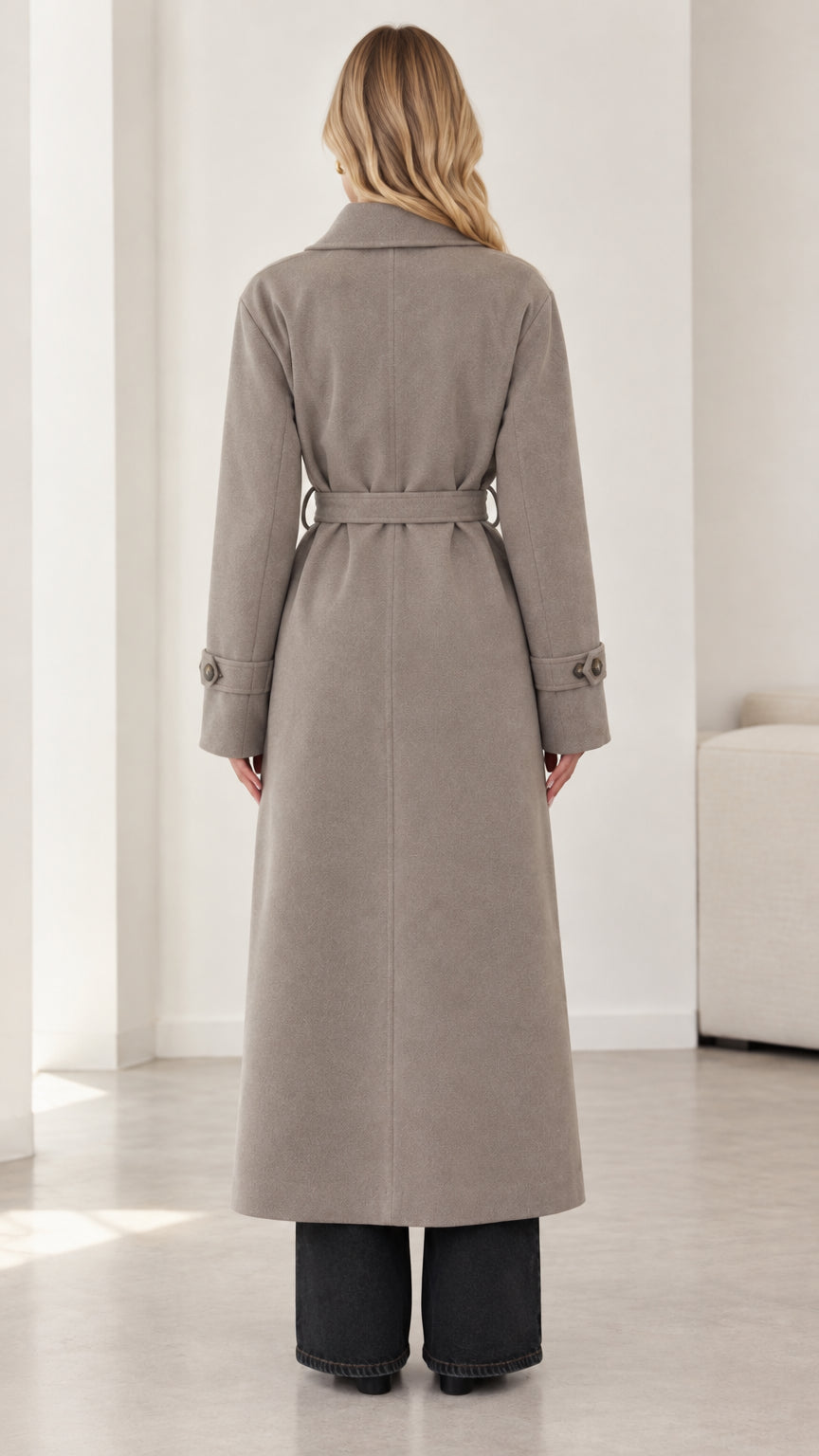 Back view of model showcasing full length and waist belt of taupe maxi coat