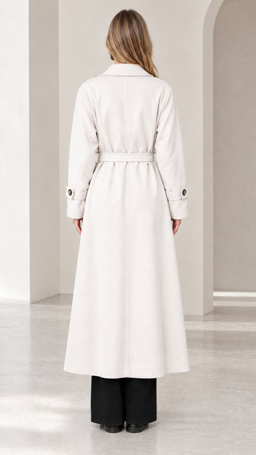 Back view of woman wearing cream tailored long overcoat