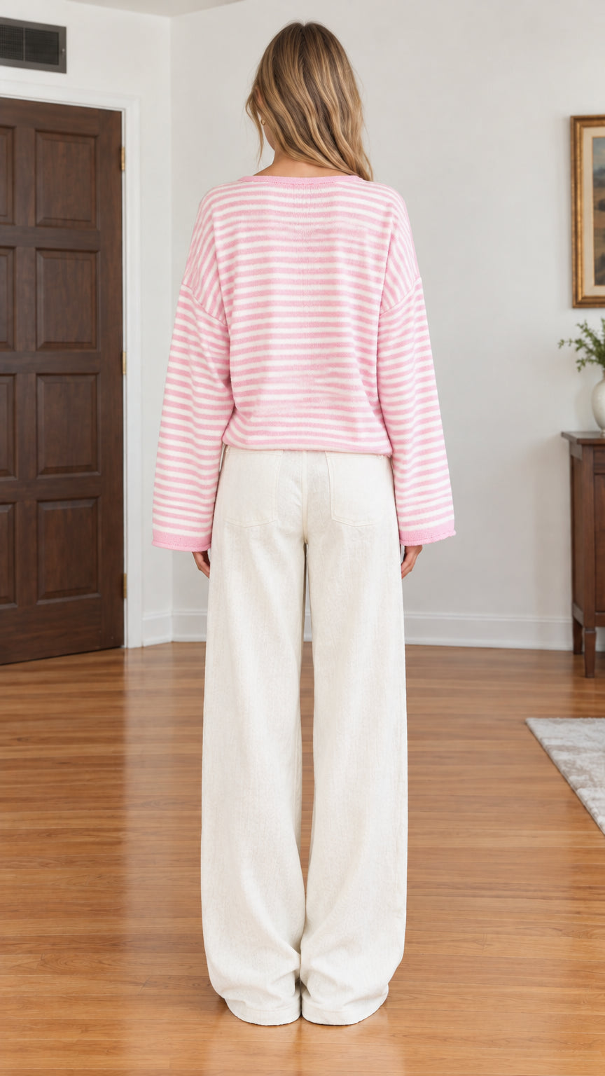 Back full-length view of pink and white striped long sleeve knit cardigan