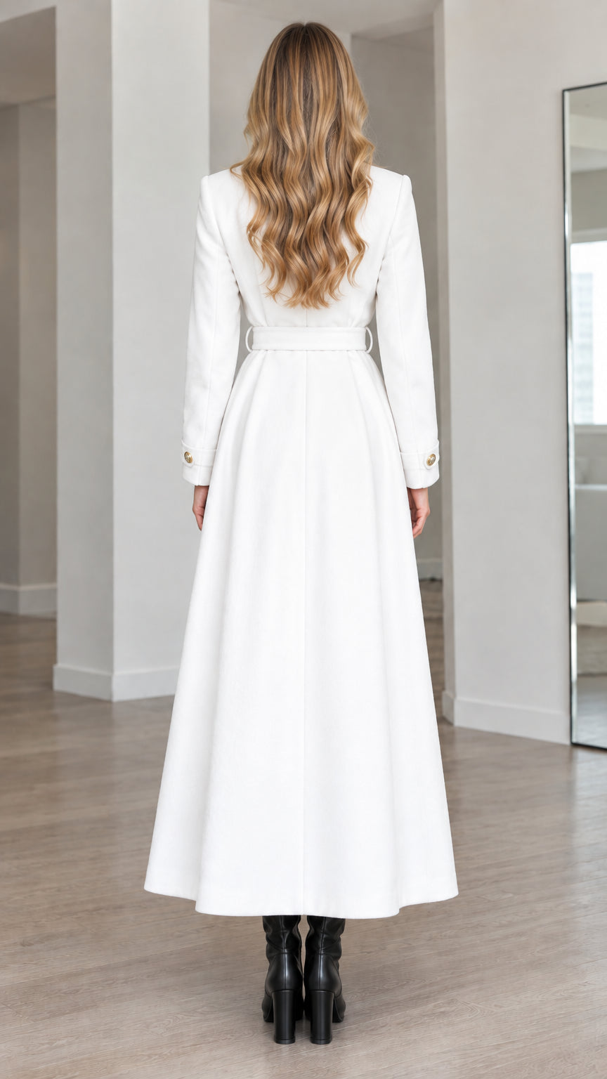 Back view of model wearing white long flared trench coat