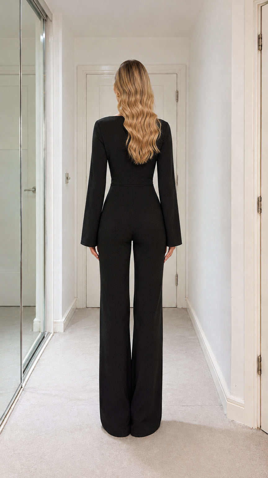 Back full-length view of model showing sleek fit and wide-leg silhouette of black jumpsuit