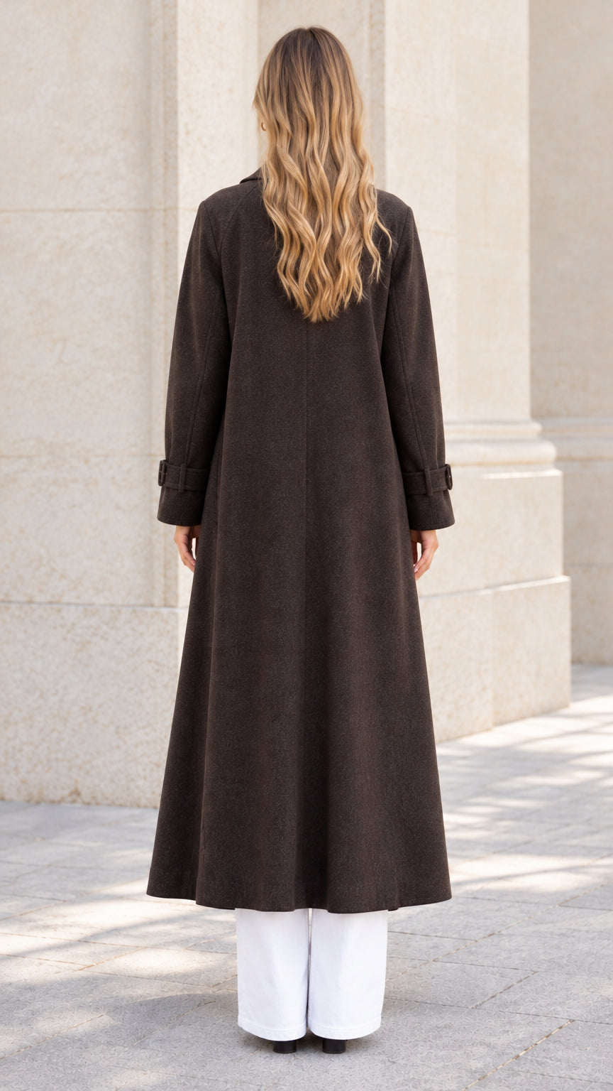 Back view of woman wearing full-length dark brown overcoat