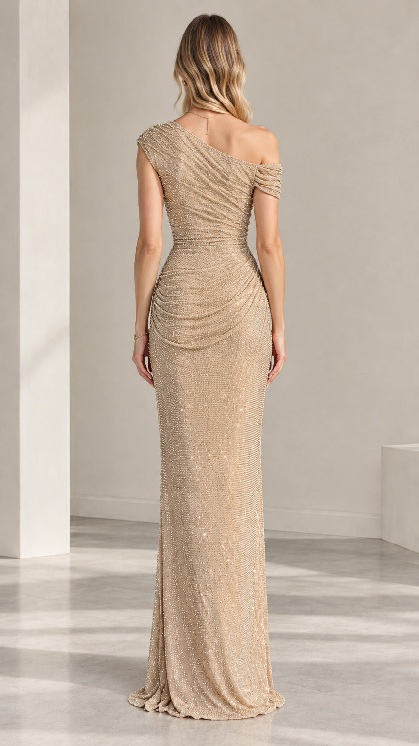 Back view of model wearing champagne ruched sequin one-shoulder maxi dress
