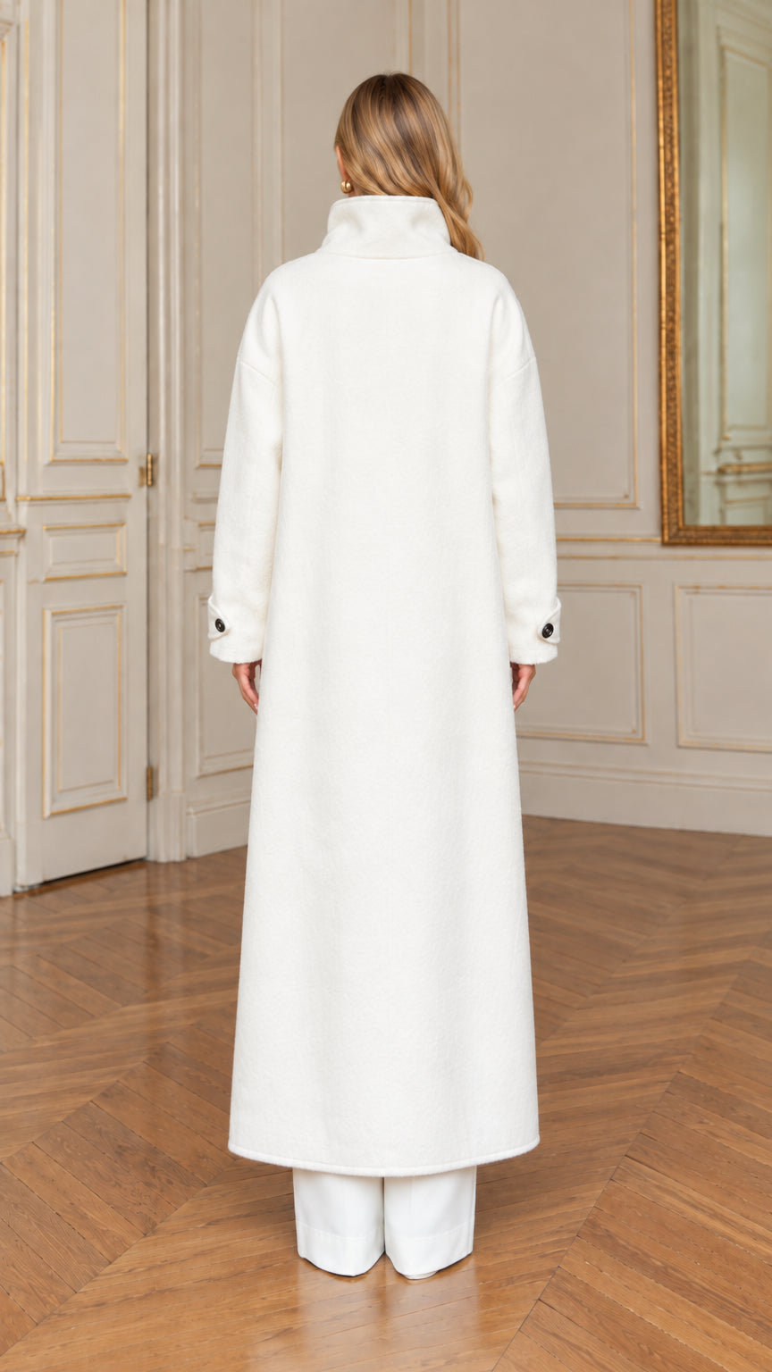 Rear back view showing the straight tailored silhouette of the off-white maxi coat