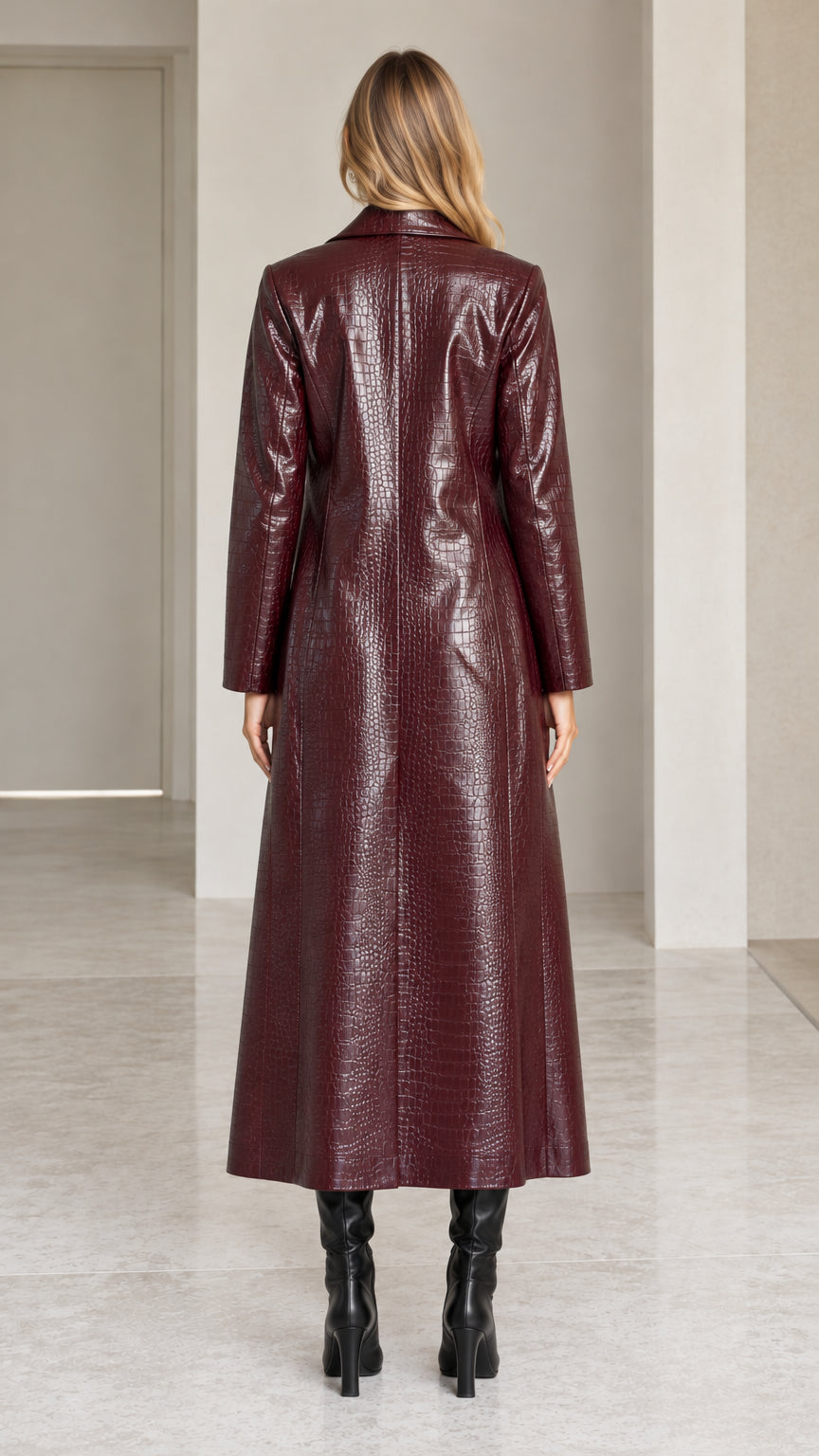 Back view of model in ankle-length burgundy croc-embossed trench coat
