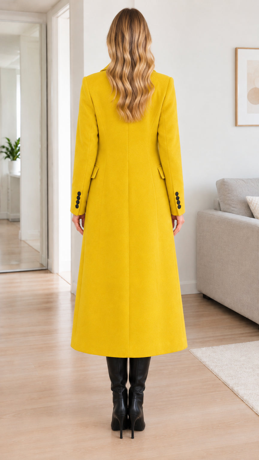 Back view of model showing the clean lines and sleek fit of the yellow longline overcoat