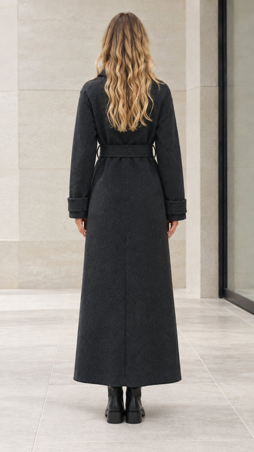 Back view of woman wearing full length black maxi overcoat showing clean tailoring