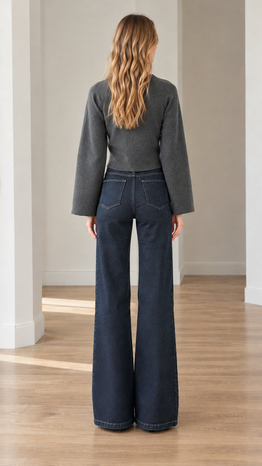 Back view of model wearing charcoal grey cropped cardigan with raglan seam detailing
