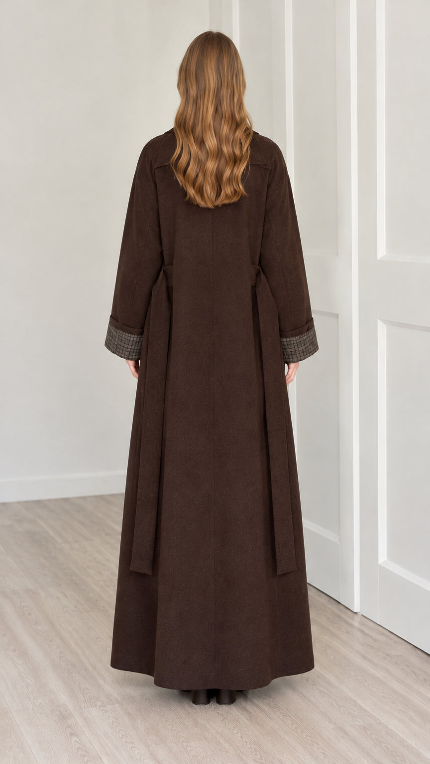 Back view of woman wearing full length brown longline coat