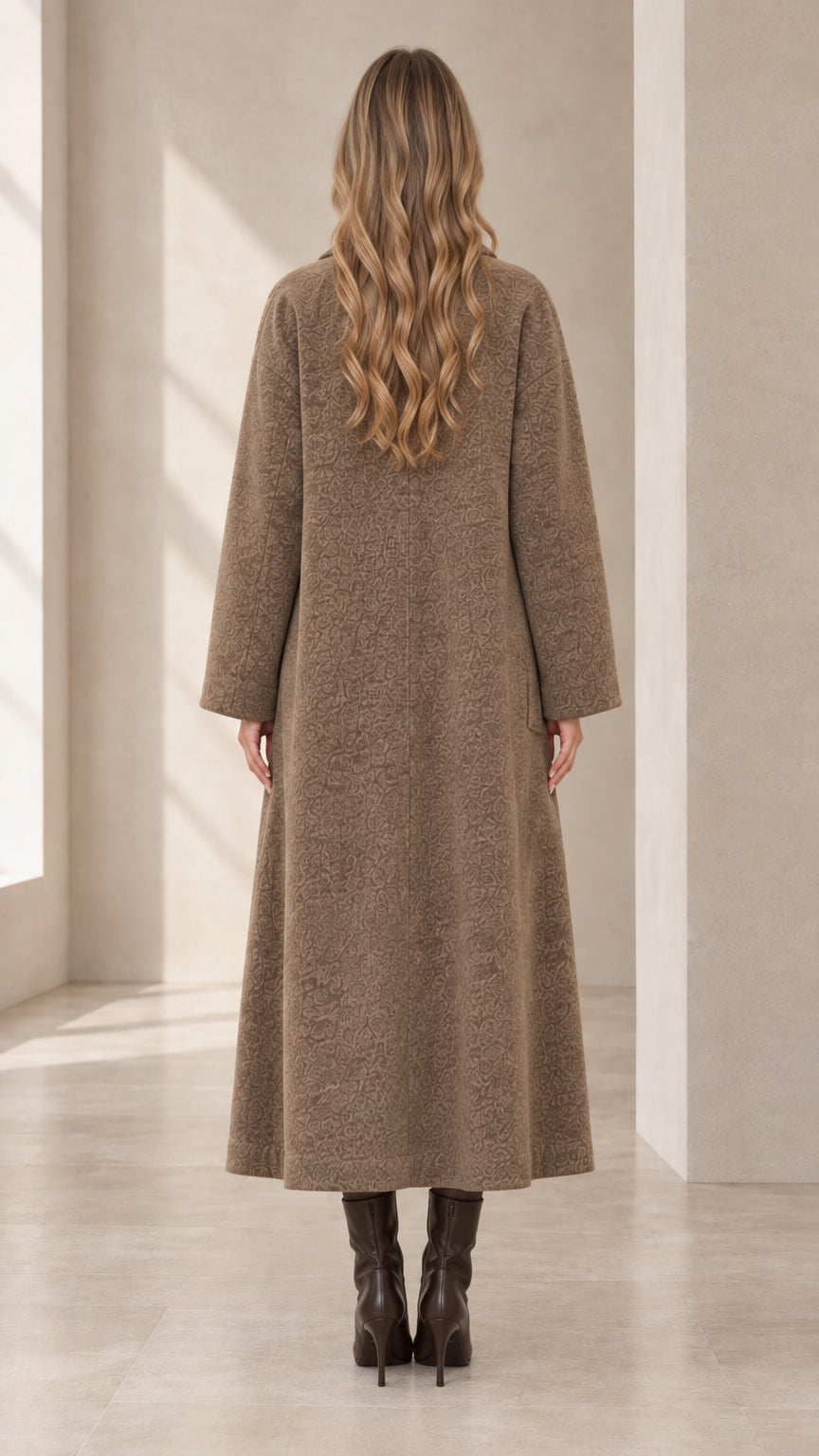Back view of model wearing the long mocha tailored overcoat