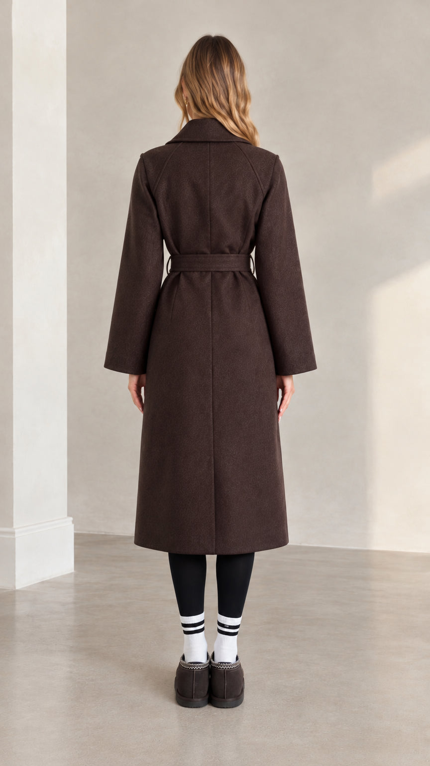 Back full view of woman wearing brown longline belted coat