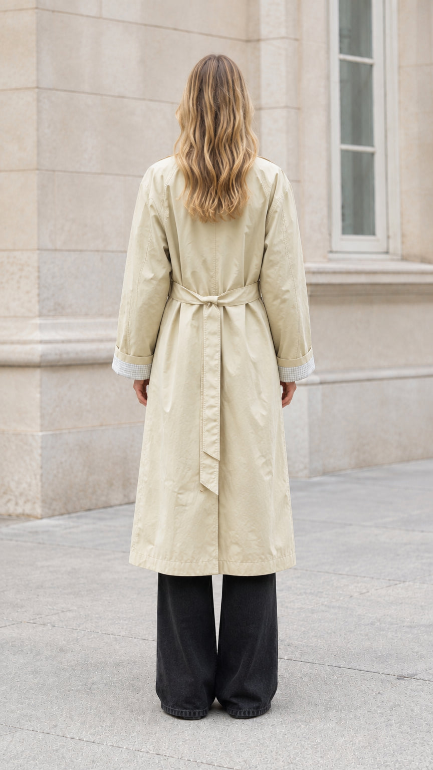 Back full-length view of beige trench coat showing tied waist belt and relaxed silhouette