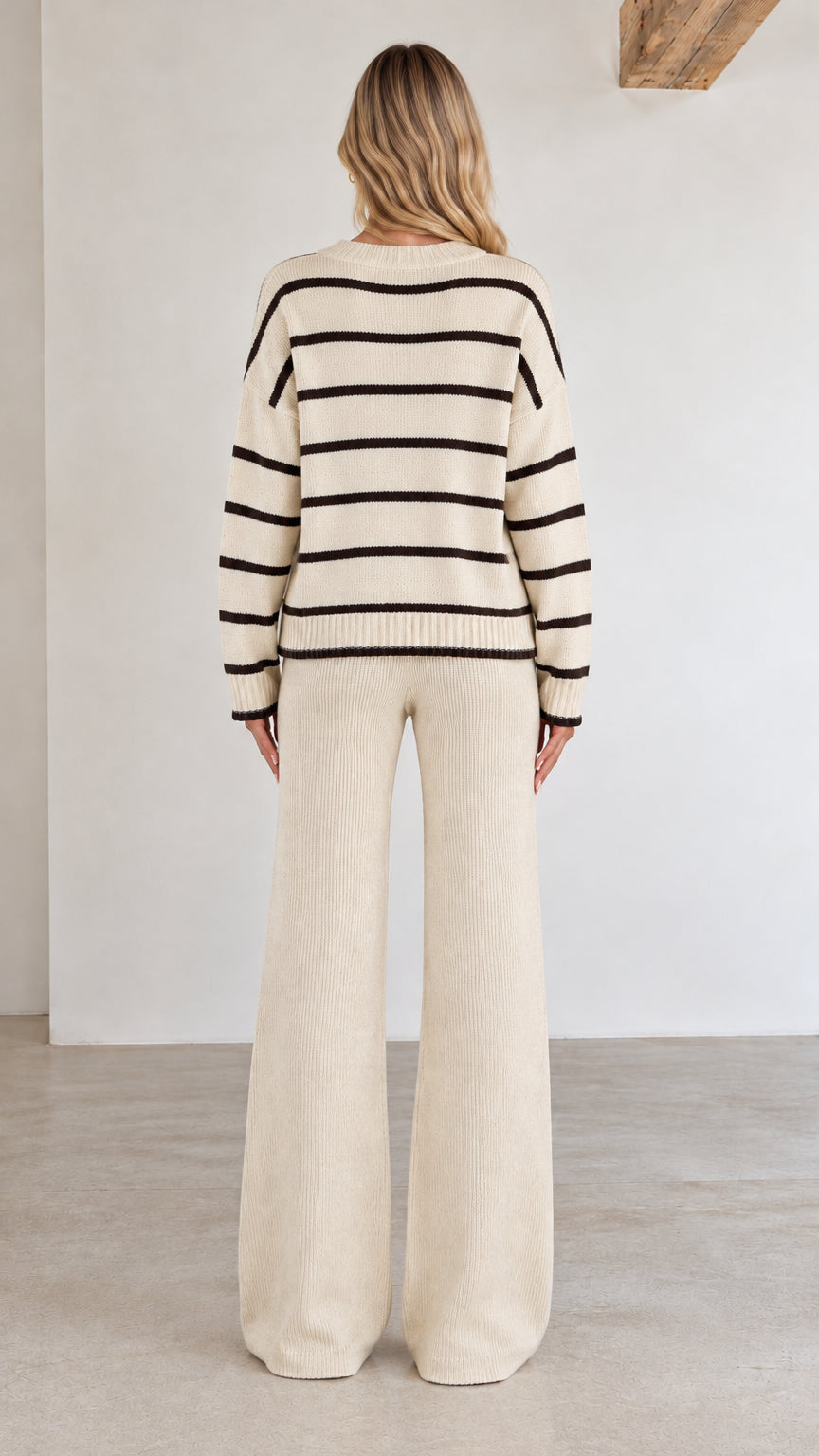 Back view of cream striped button cardigan and wide-leg knit pants