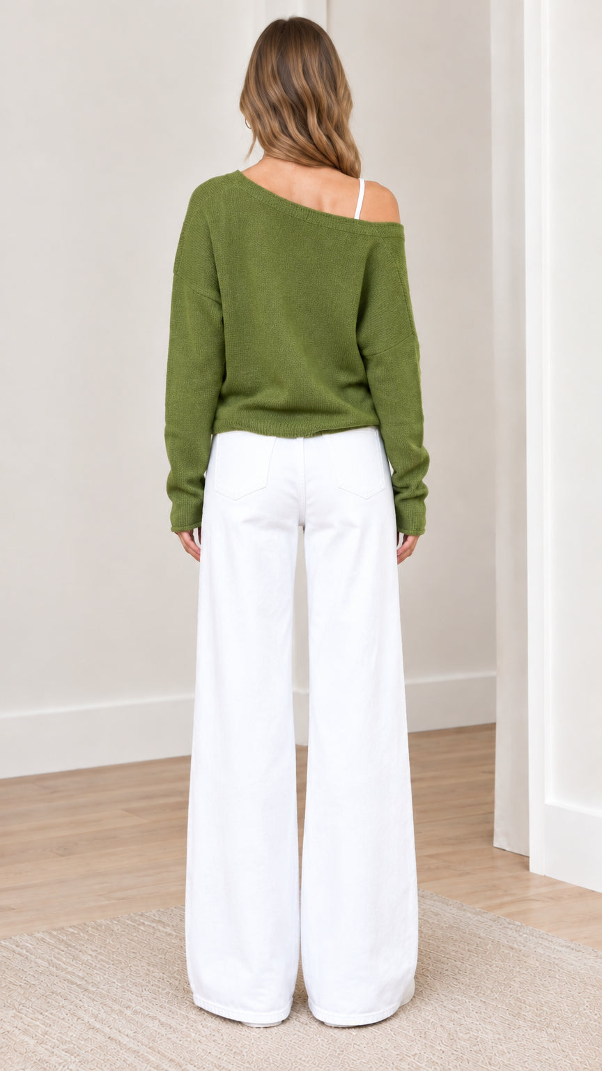Back view of woman wearing green long sleeve knit cardigan sweater