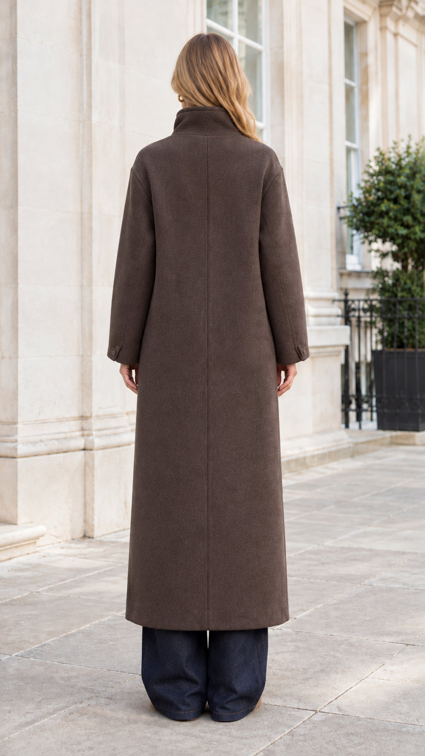 Back view of woman wearing full-length structured brown winter coat