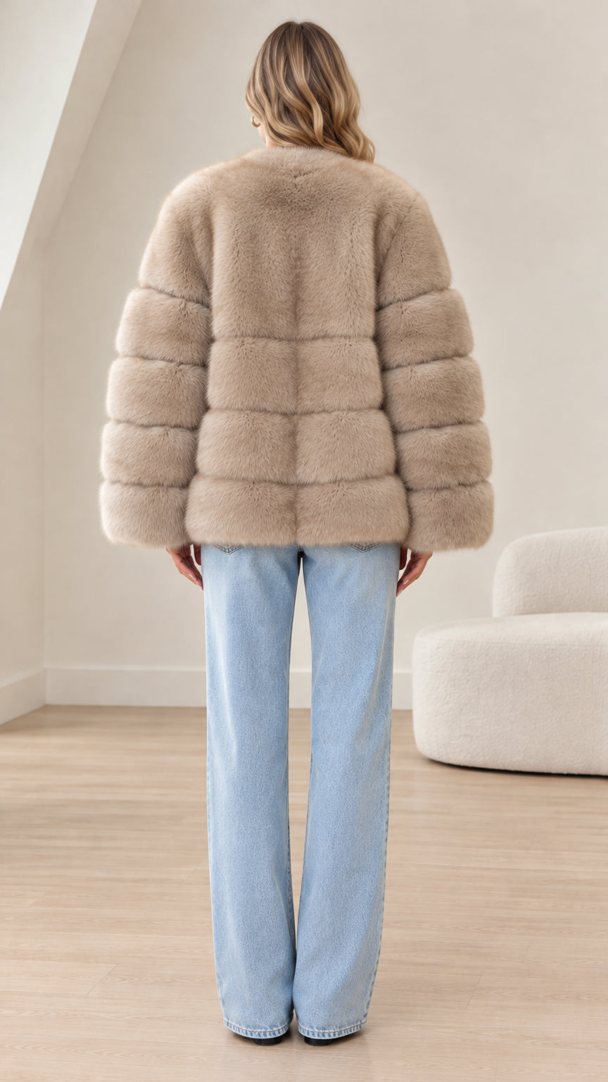 Back view of model wearing taupe faux fur paneled jacket showing horizontal ribbed bands