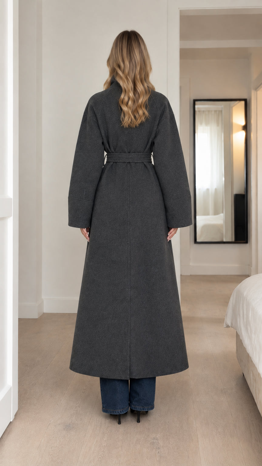 Back full-length view of model wearing charcoal maxi trench coat