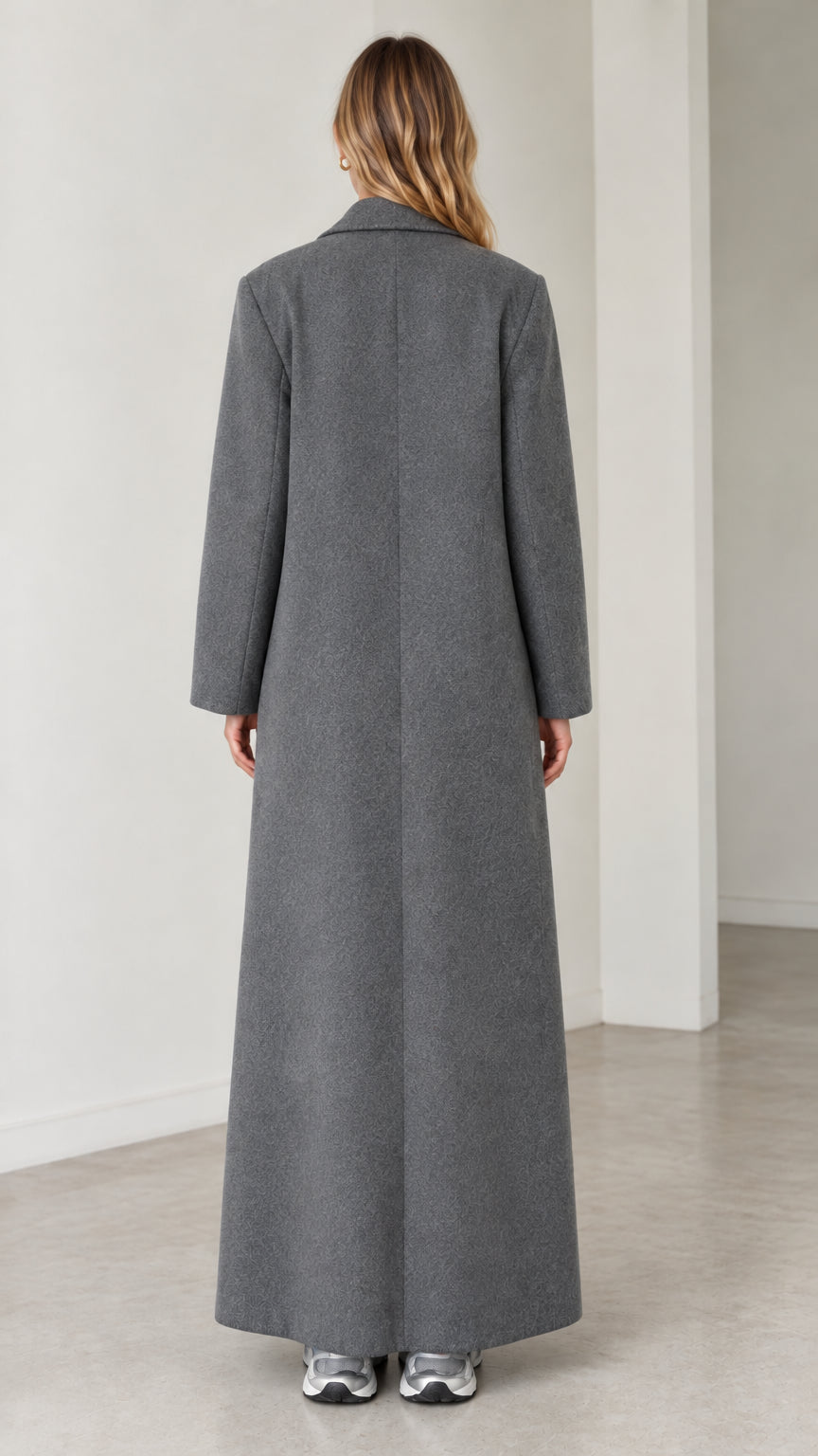 Back view of model wearing the grey maxi overcoat showing clean shoulder seams and center back line