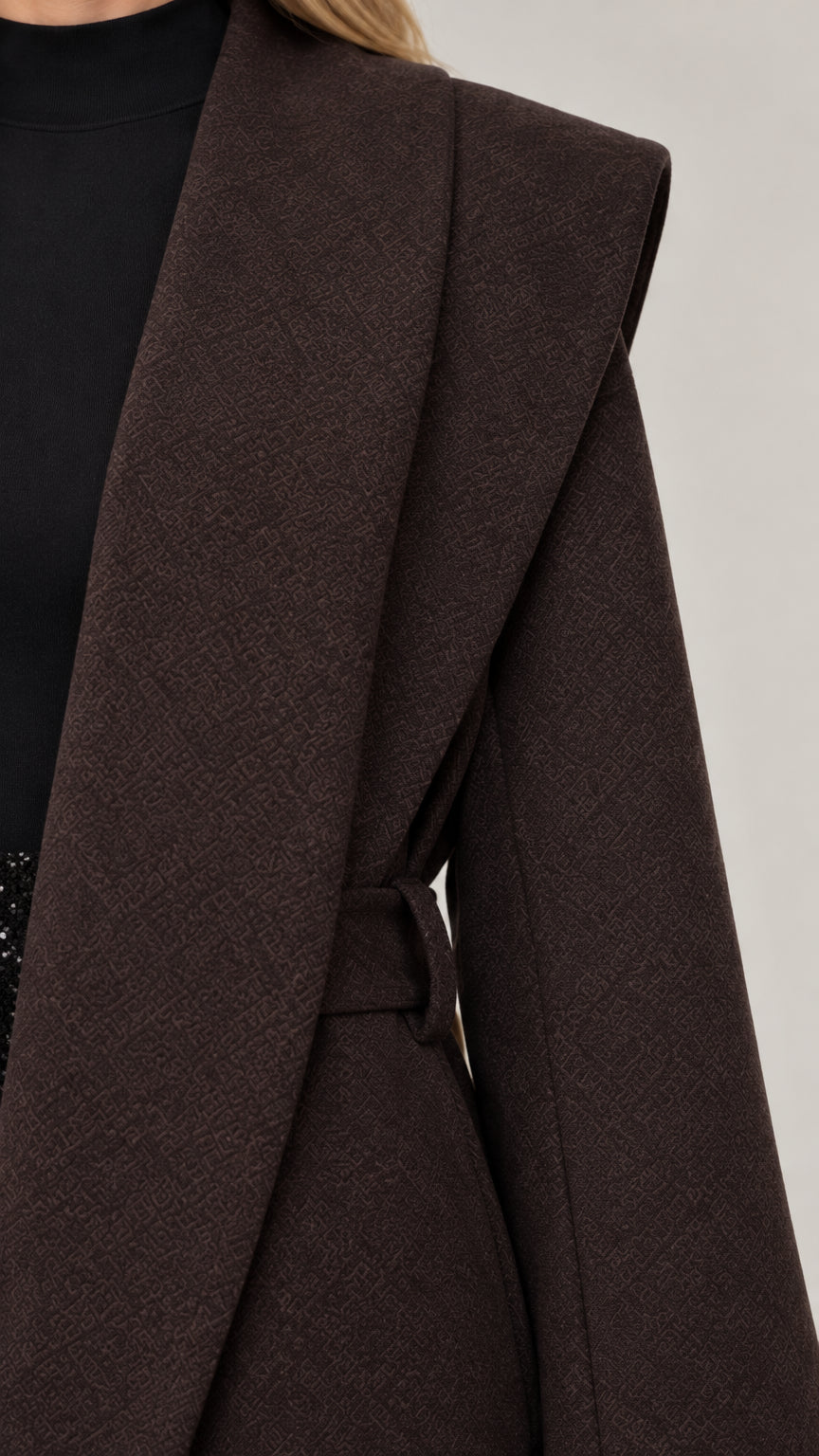 Close-up detail of dark brown woven coat lapel and shoulder structure