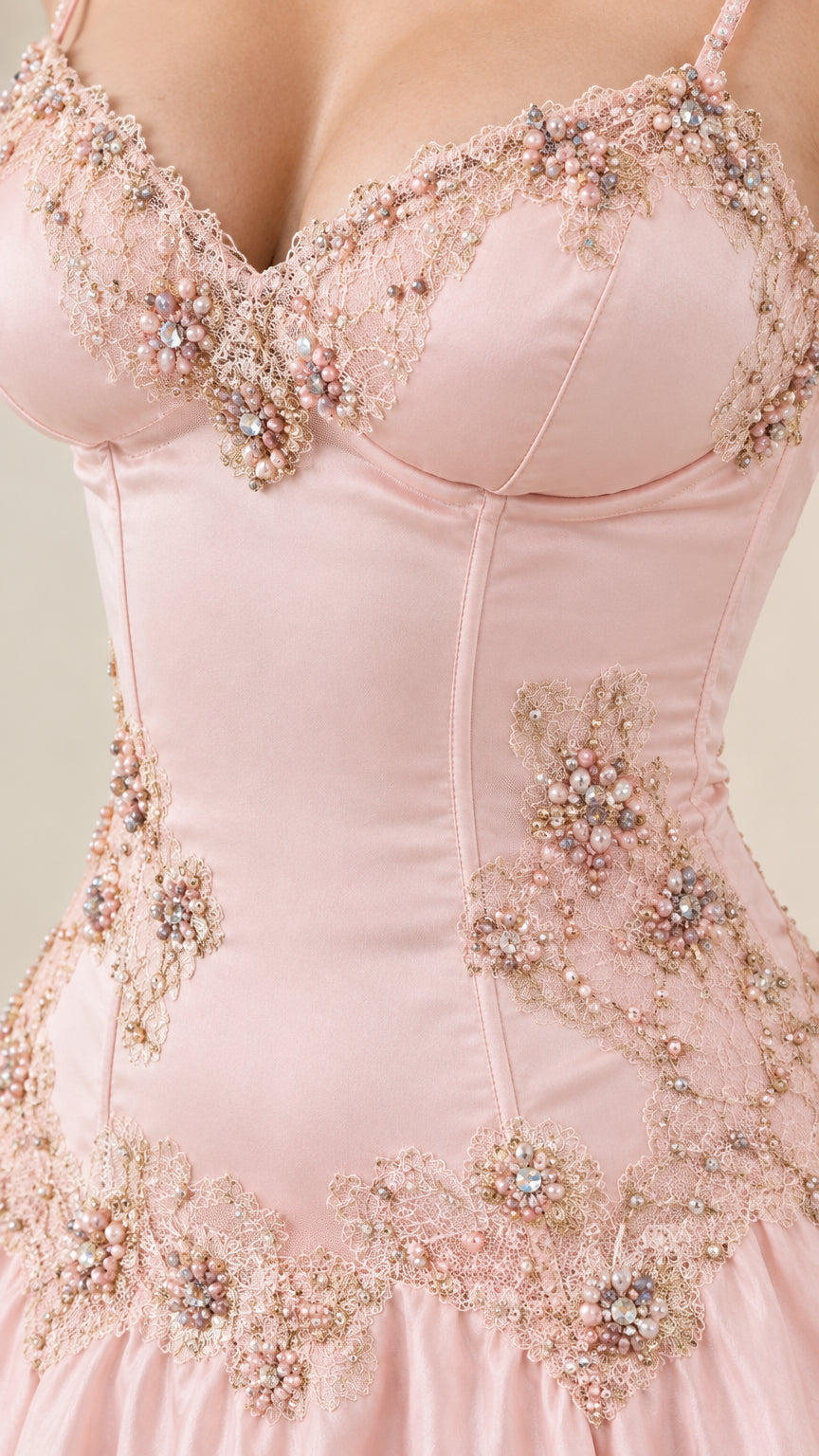 Close up of intricate pearl and bead floral embroidery on corset sweetheart bodice