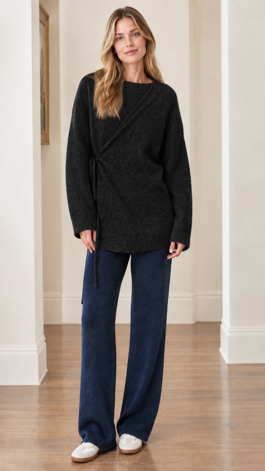 Woman wearing Black asymmetrical side-tie long sleeve knit sweater