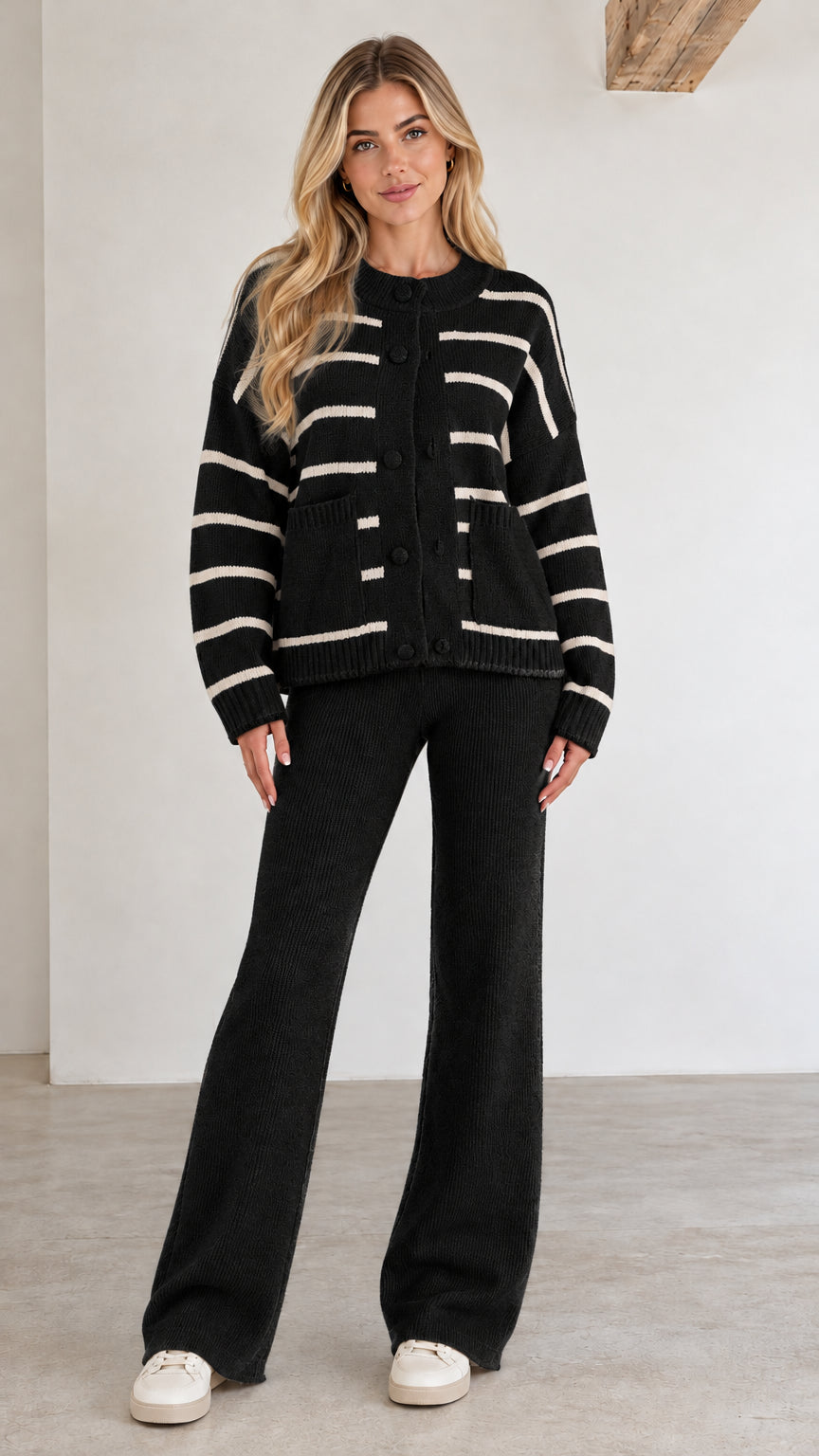 Front view of black striped knit cardigan and wide-leg lounge pants set