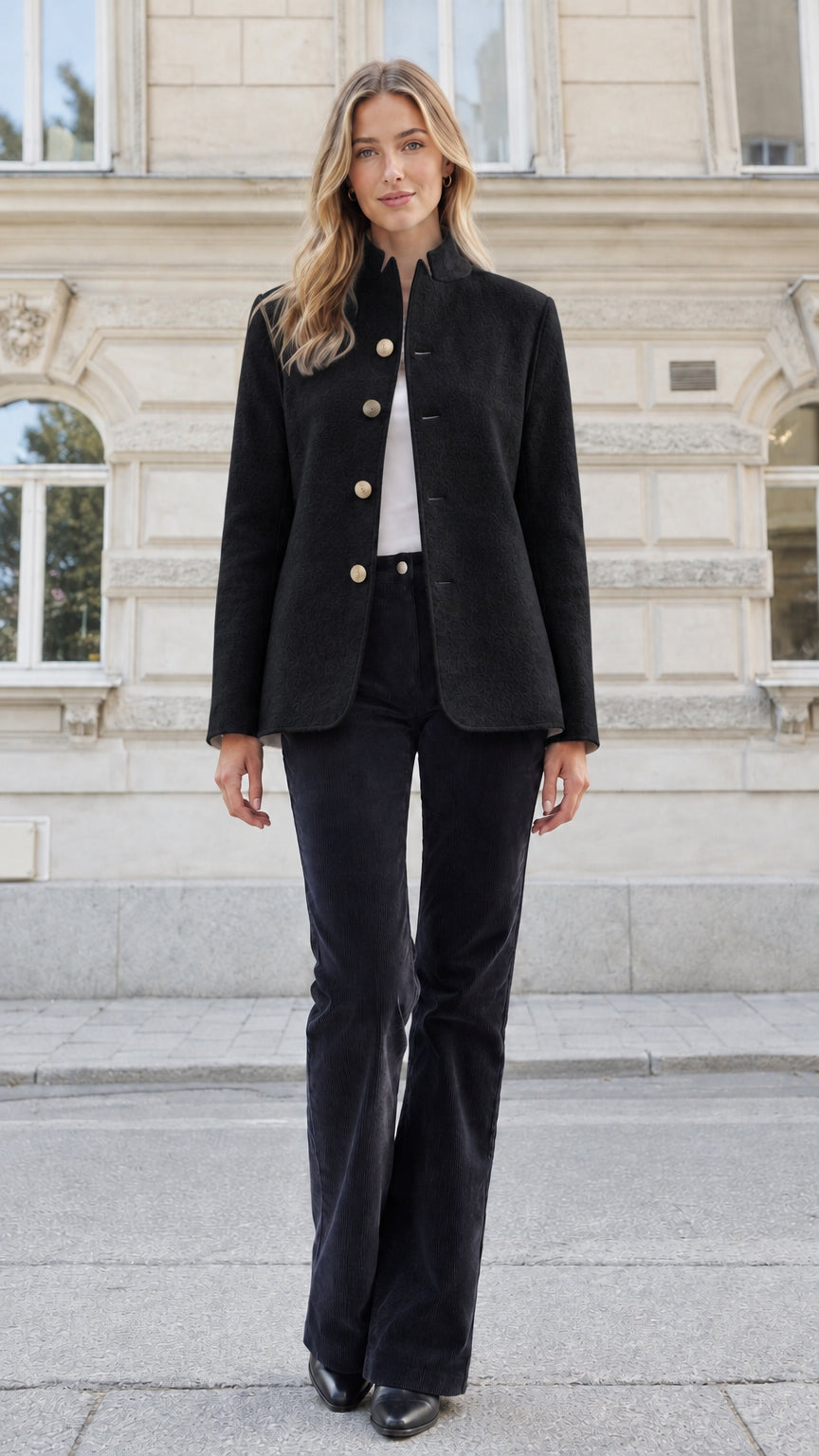 Front view of a woman wearing a black textured stand collar tailored blazer jacket