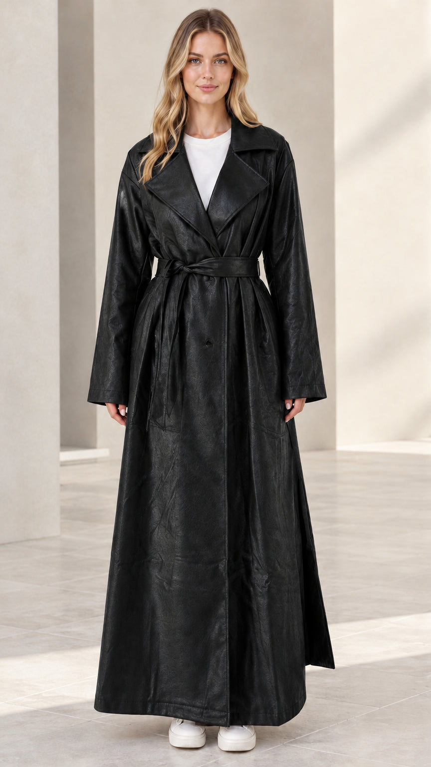 Front view of woman wearing black maxi faux leather trench coat
