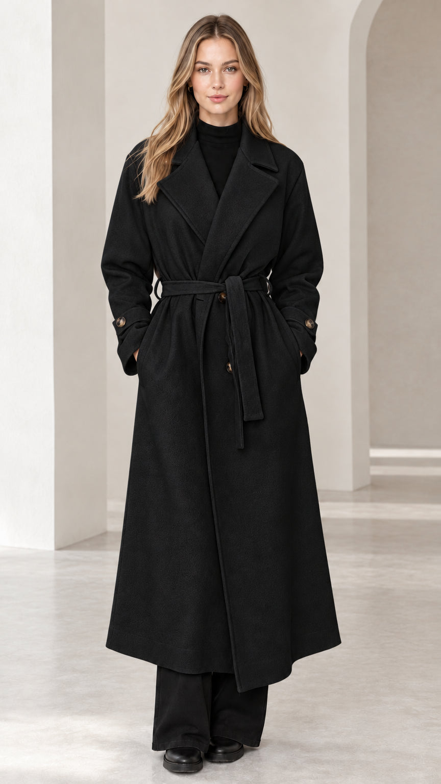 Front view of woman wearing black long belted trench overcoat