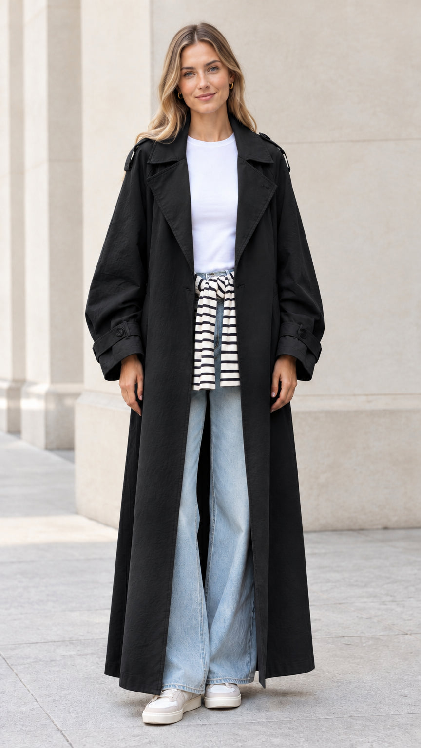 Front full view of woman wearing black oversized maxi trench coat