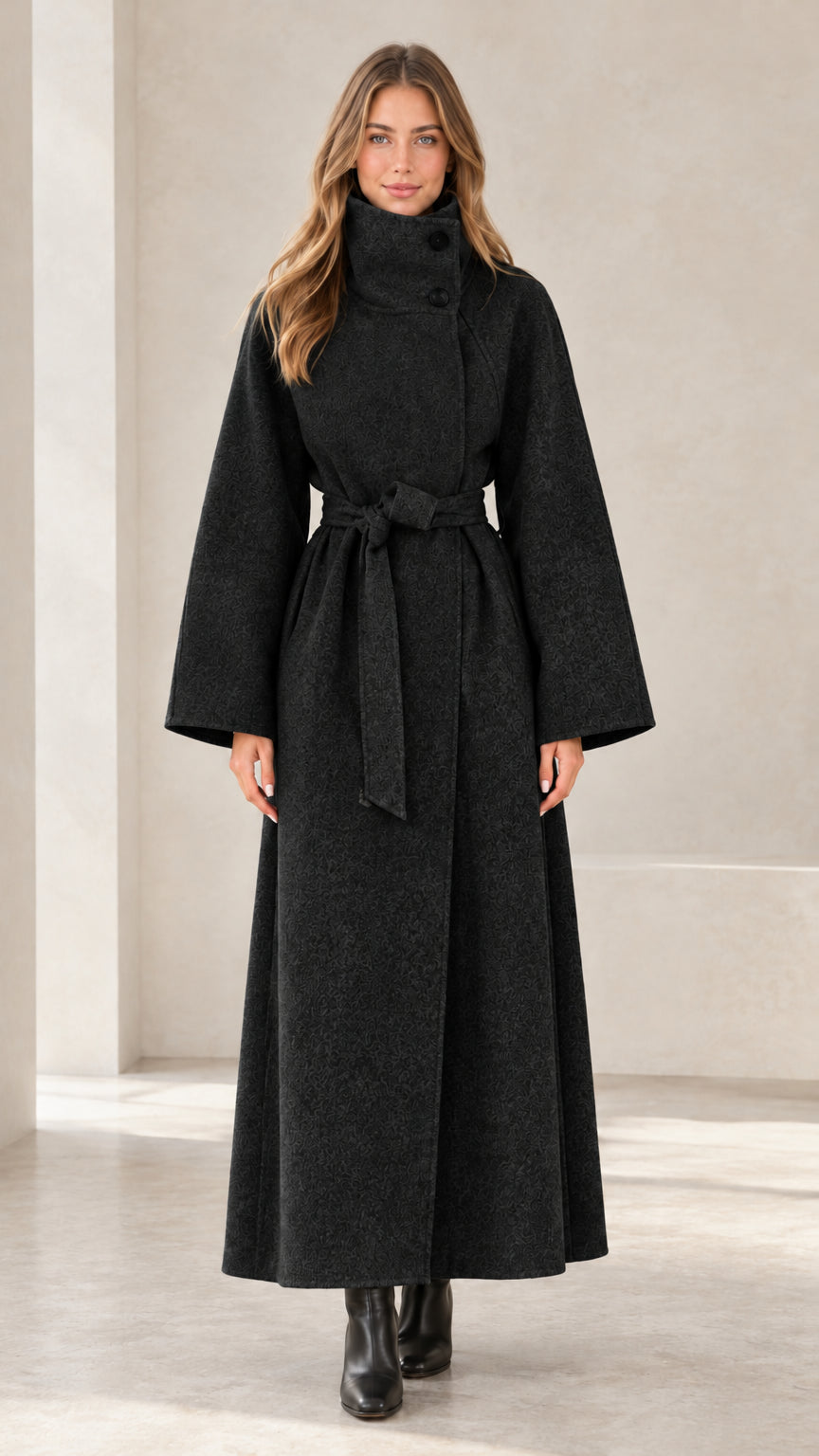 Front view of women's black high-neck maxi belted trench coat