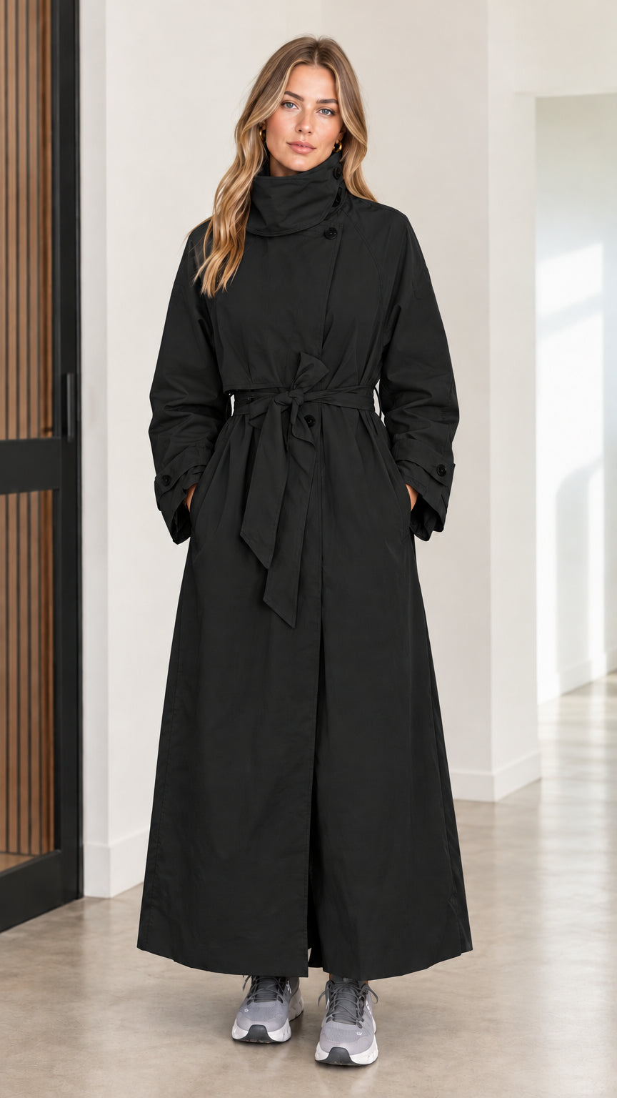 Full front view of women's black high neck maxi belted trench coat