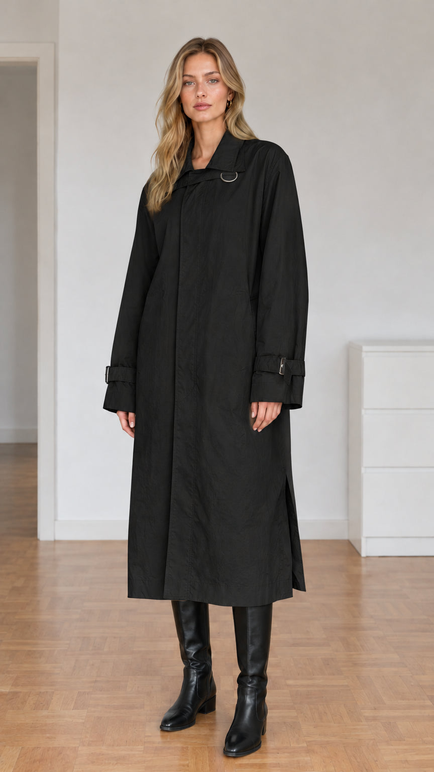 Front view of model wearing black longline trench coat