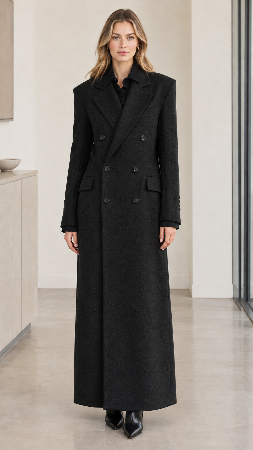 Front full-length view of woman wearing black double-breasted maxi overcoat