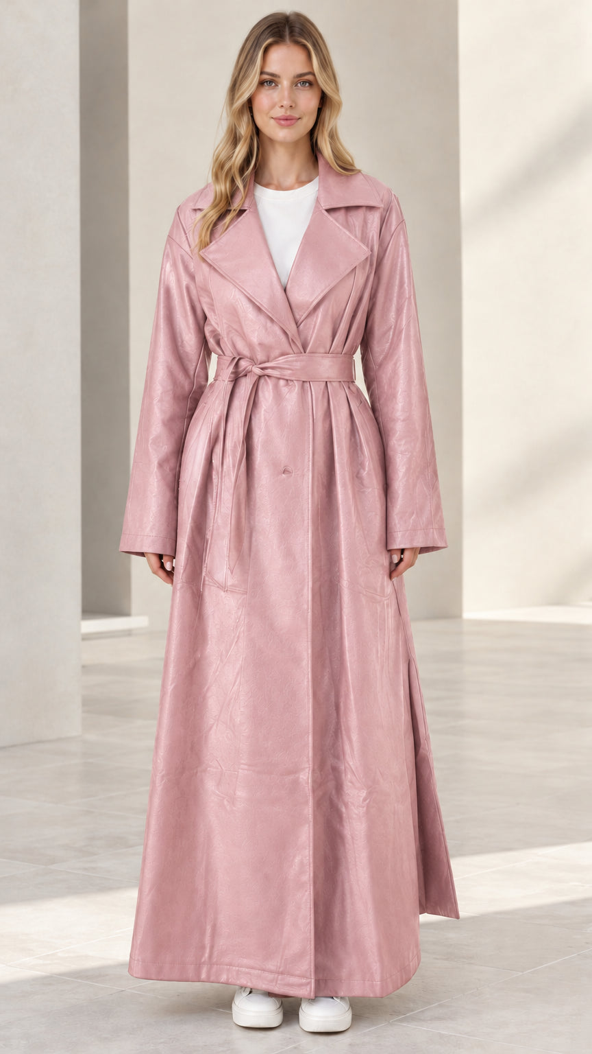 Front view of woman wearing dusty pink maxi faux leather trench coat