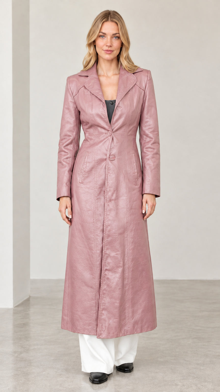 Full-length front view of woman wearing dusty pink textured faux leather maxi coat