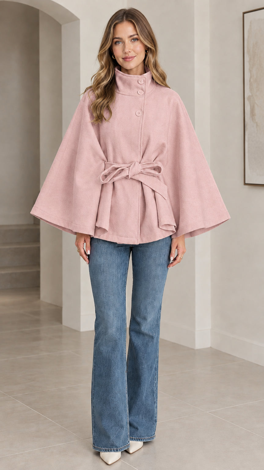 Front view of blush pink high neck belted cape coat with matching tie sash