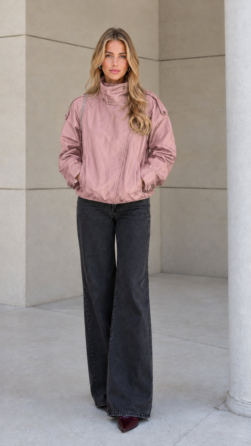 Front view of model wearing the dusty pink high-neck zip-up bomber jacket