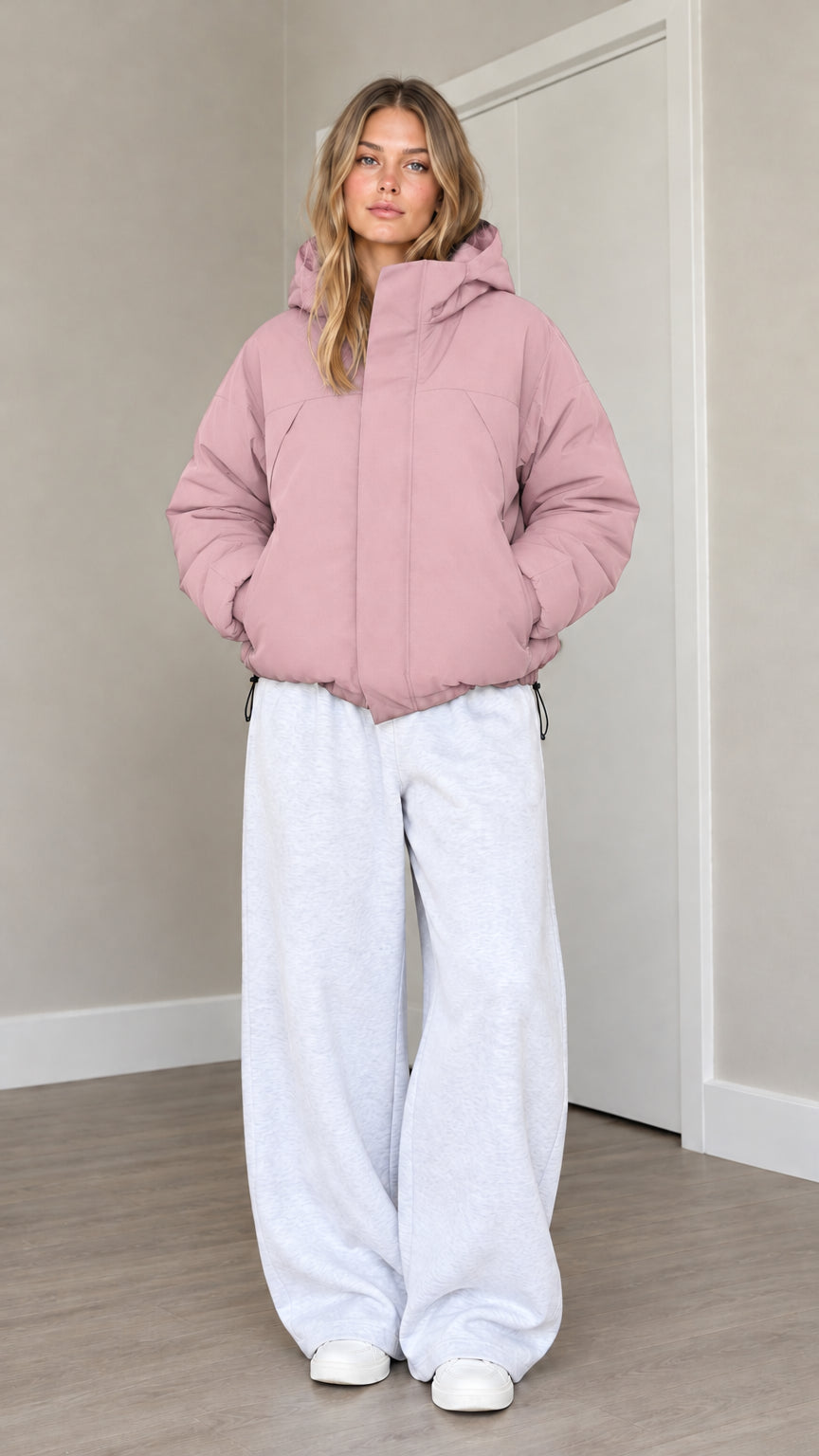 Front view of model wearing dusty pink hooded puffer jacket