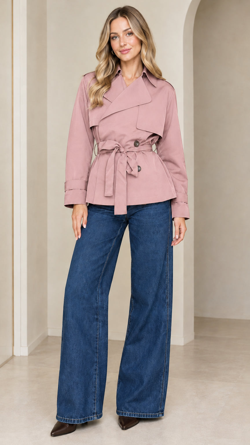 Front view of model wearing the cropped belted trench jacket in soft dusty pink