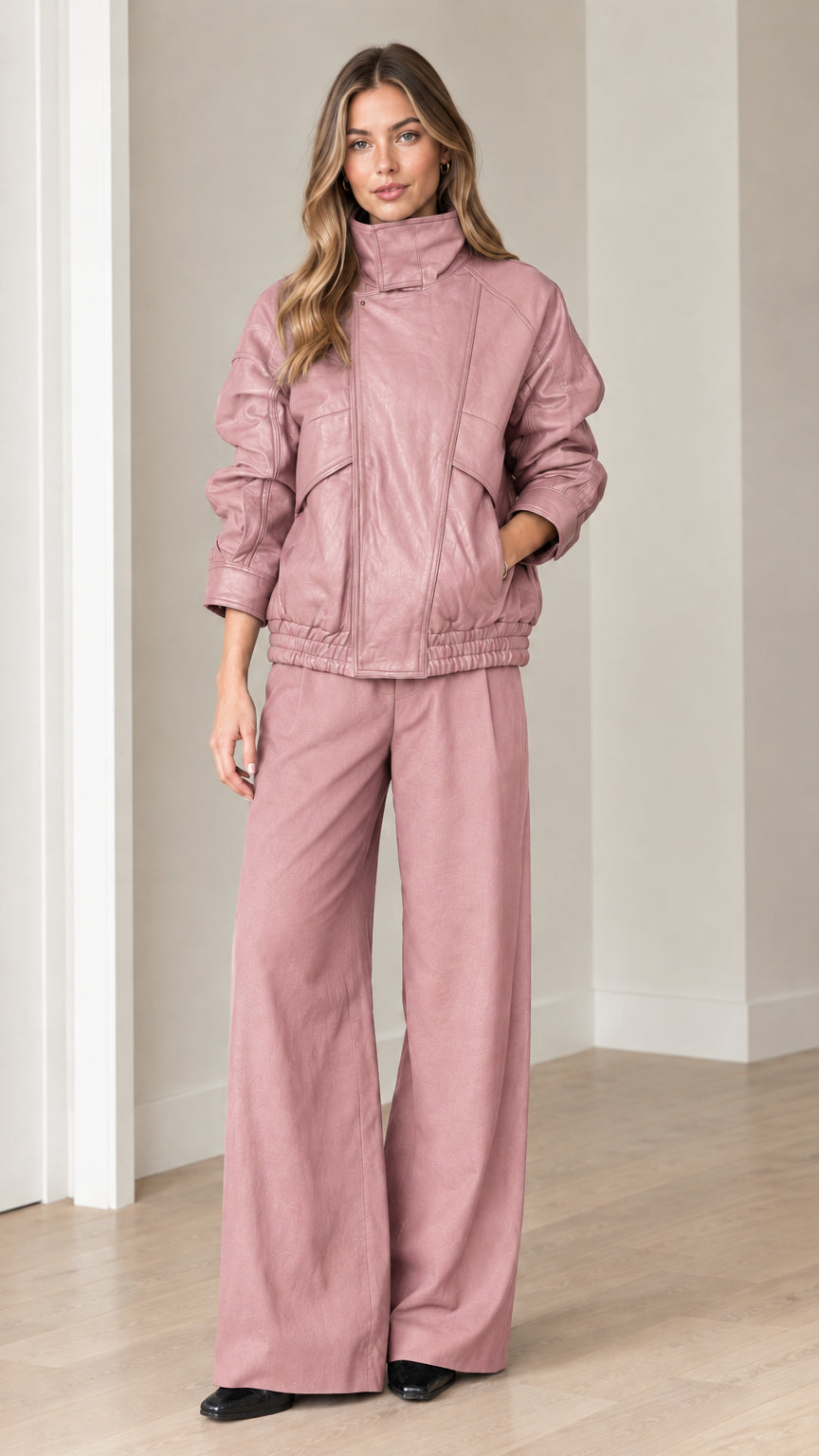 Front view of model wearing dusty pink faux leather bomber jacket and wide-leg pants set