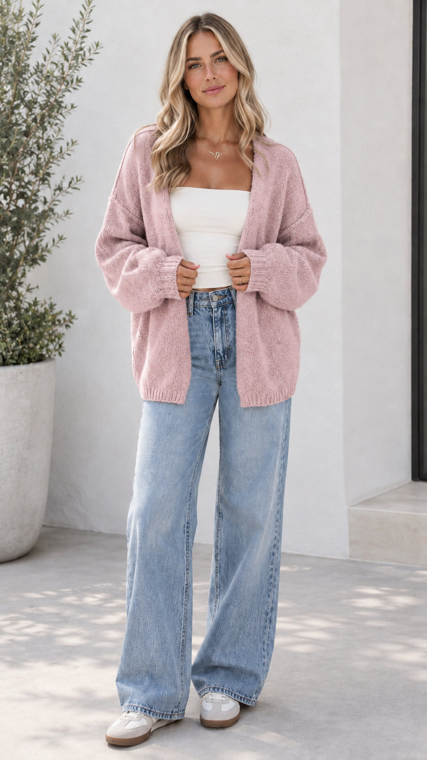 Model wearing dusty pink open front oversized knit cardigan with light blue jeans