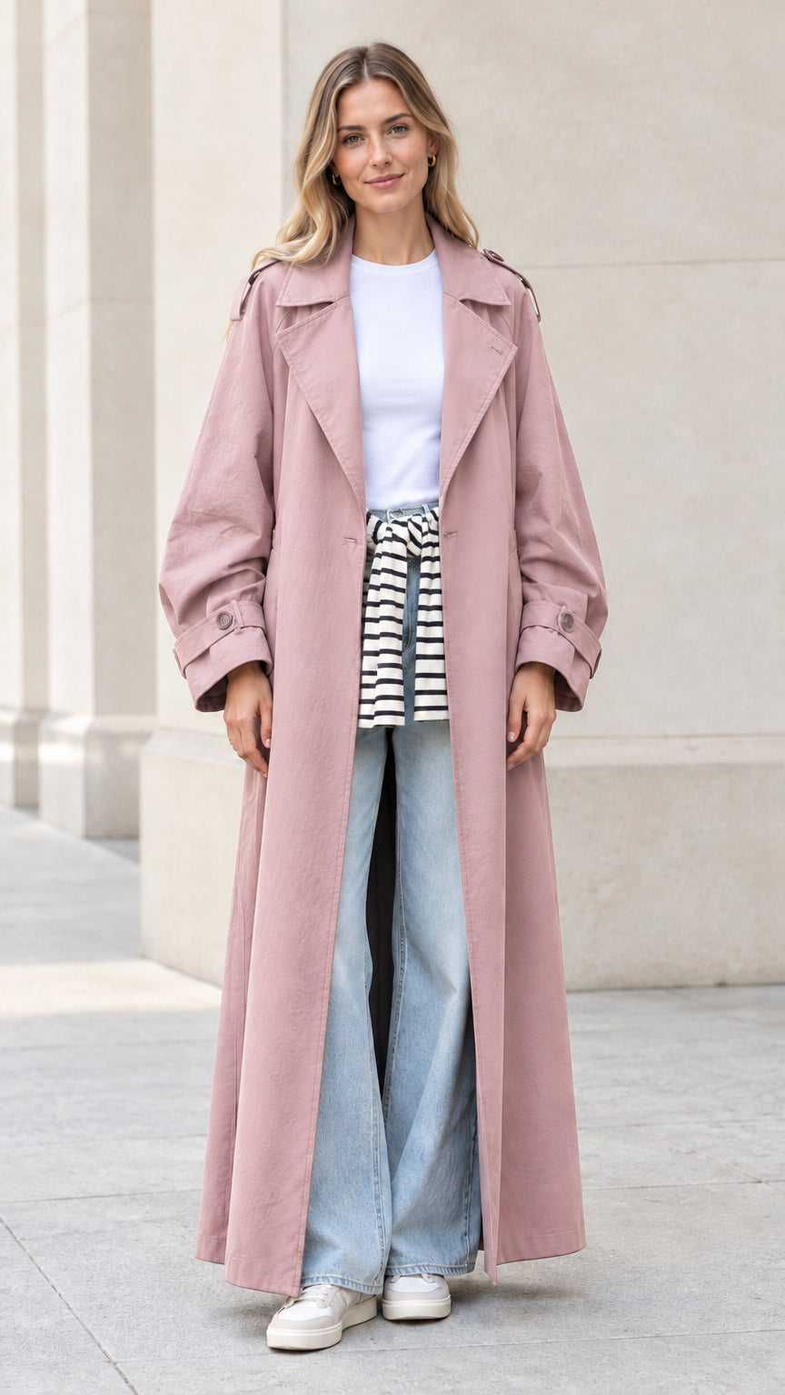Front full view of woman wearing dusty pink long duster trench coat