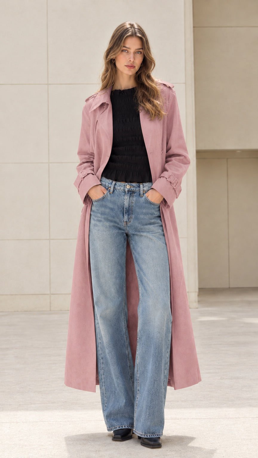 Front open view of woman wearing long dusty pink trench coat over casual outfit