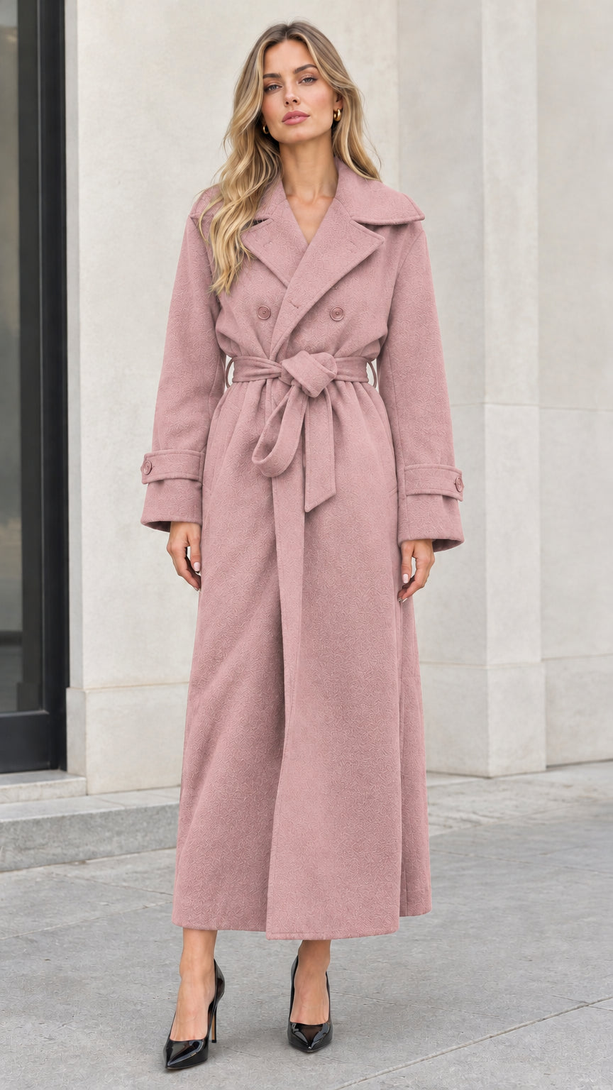 Front full-length view of woman wearing dusty pink double-breasted maxi trench coat