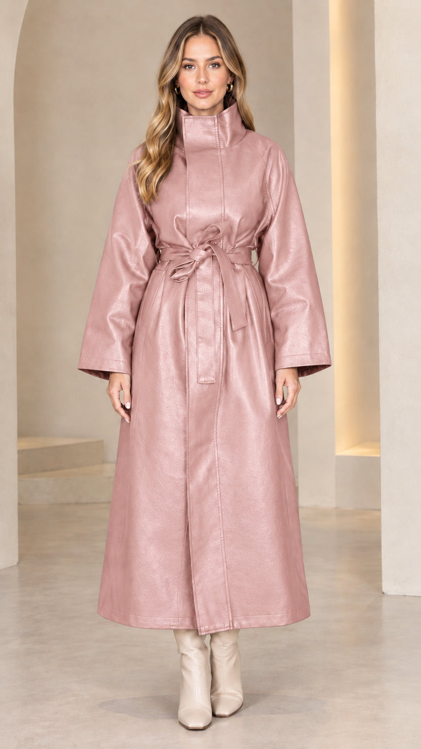 Front view of model wearing dusty pink belted faux leather maxi trench coat