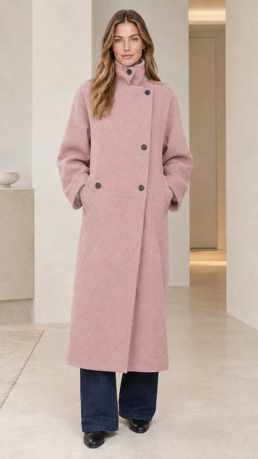 Front view of model wearing dusty pink asymmetric button stand collar overcoat