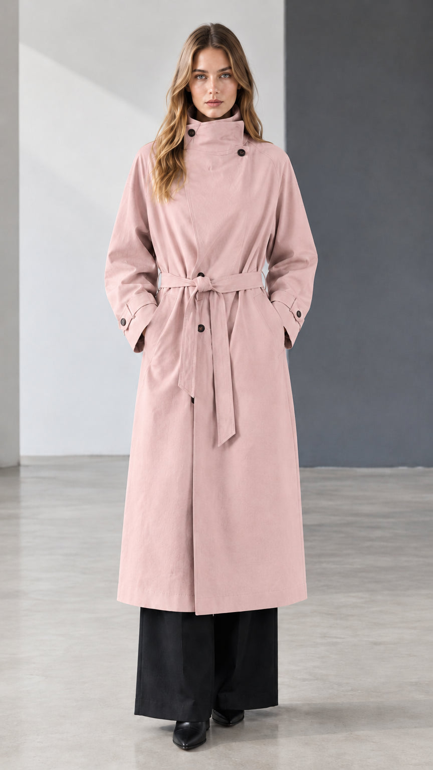 Front view of model wearing dusty pink belted longline trench coat