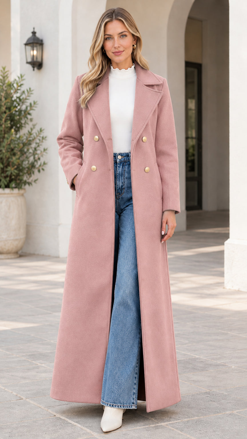 Front view of model wearing the double-breasted floor-length maxi coat in dusty pink